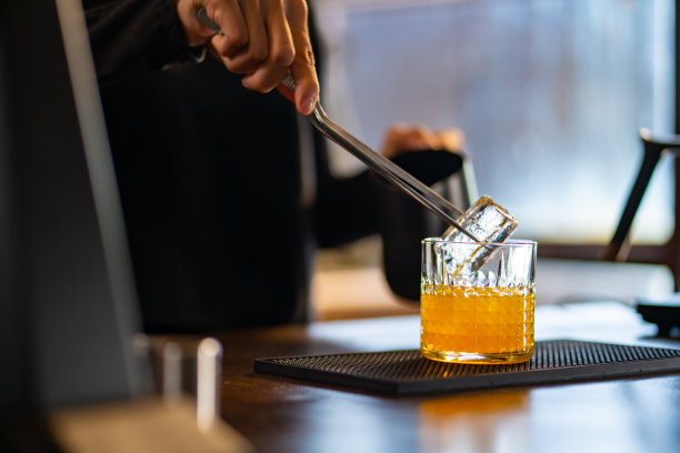 亚洲女咖啡师制作加橙汁的冰黑咖啡给顾客图片下载