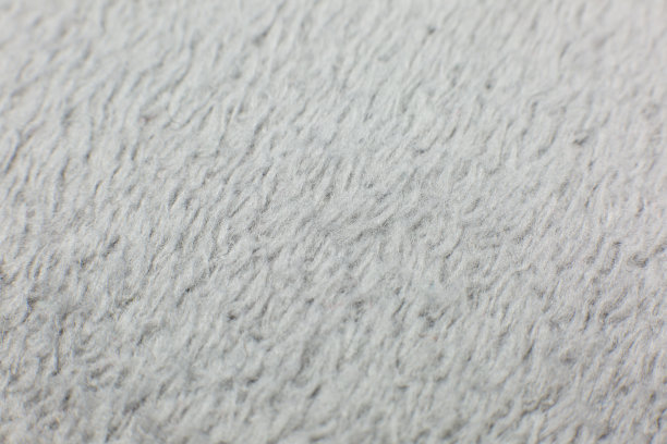 灰色棉布毛巾或地毯。毛茸茸的纹理背景。特写，微距照片。软焦点的形象。图片下载