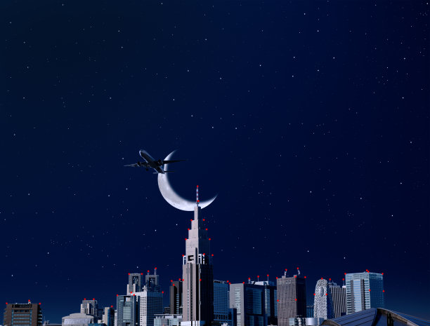 飞机在东京新宿上空飞过新月。图片下载