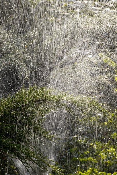 现代园林灌溉设备。灌溉系统-花园灌溉技术。草坪喷水器将水喷洒在绿色上图片下载