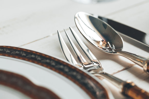 近距离拍摄的餐桌设置精美的餐具和玻璃器皿图片下载