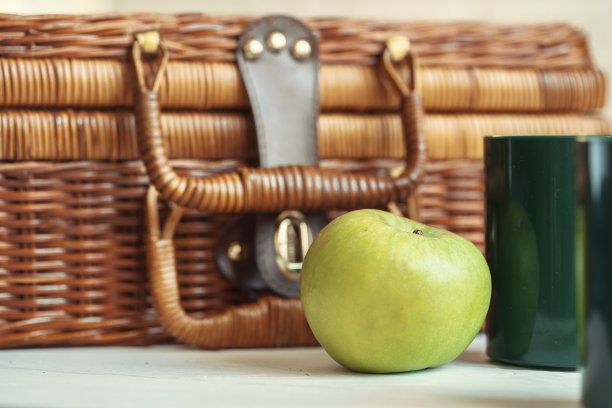 白色的桌子上有一个木制的篮子和餐具图片下载