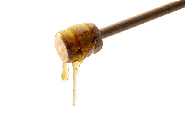 蜂蜜从木蜂蜜勺上滴下来图片下载