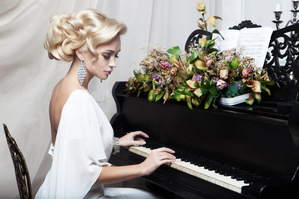 美丽的年轻新娘在弹钢琴图片下载