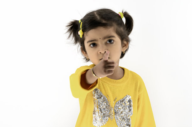 人们情绪的概念。被冒犯的女孩的肖像与愤怒的姿势，看着摄像机在白色的工作室背景。图片下载