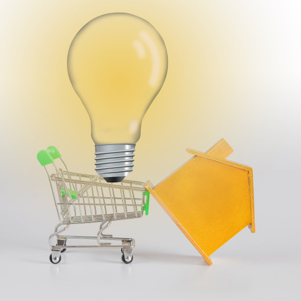 黄金房子与灯泡在购物车，住房和房地产概念。图片下载