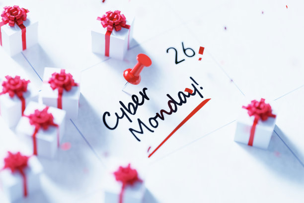 网络星期一的笔记放在用红色图钉钉在白色日历上的礼盒中间图片下载