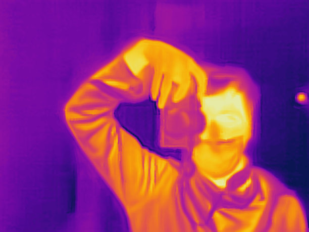 佩戴口罩的男人使用热成像相机图片下载