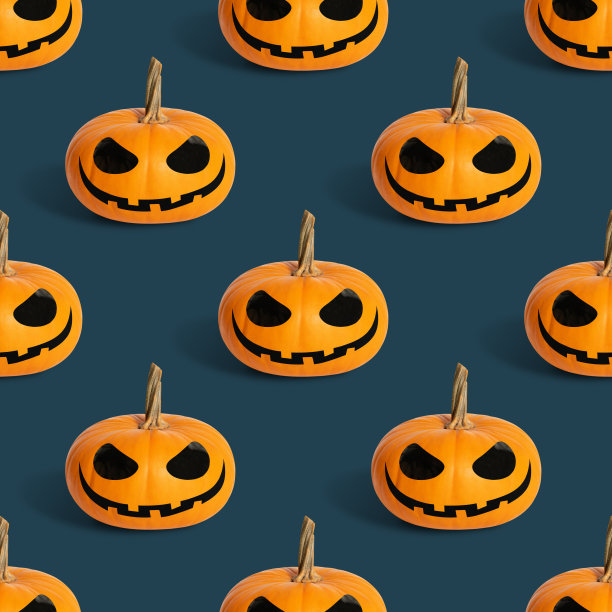 无缝模式与万圣节南瓜在蓝色背景。杰克灯笼头背景。图片下载