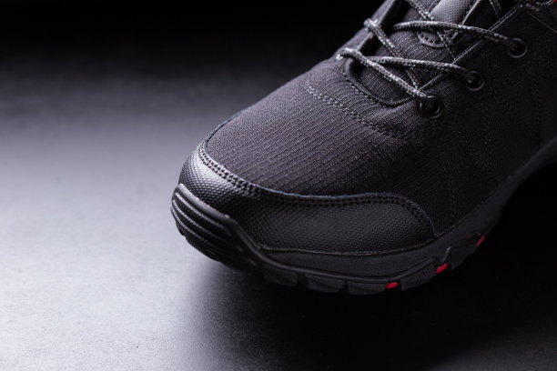 黑人男子的运动鞋特写在一个黑色孤立的背景图片下载