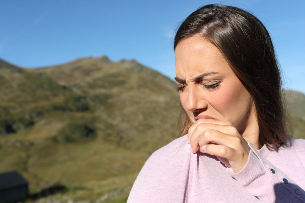 一个女人在山上闻着臭衣服图片下载