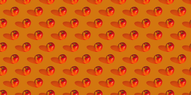 无缝模式由红苹果在橙色的背景平的照片拼贴图片下载