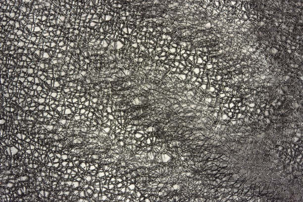 灰色蕾丝抽象背景。黑色背景设计，社交网络，文本。网眼，网眼，织物背景。图片下载