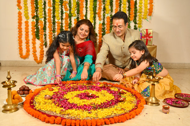 家人在排灯节穿着传统服装装饰花rangoli图片下载