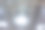 商业建筑天花板上的三个圆形LED照明灯。网状吊顶为购物中心或办公楼的内部创造了一种美丽的建筑外观。图片下载