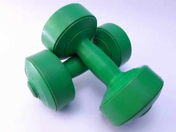 绿色哑铃孤立的白色背景图片下载