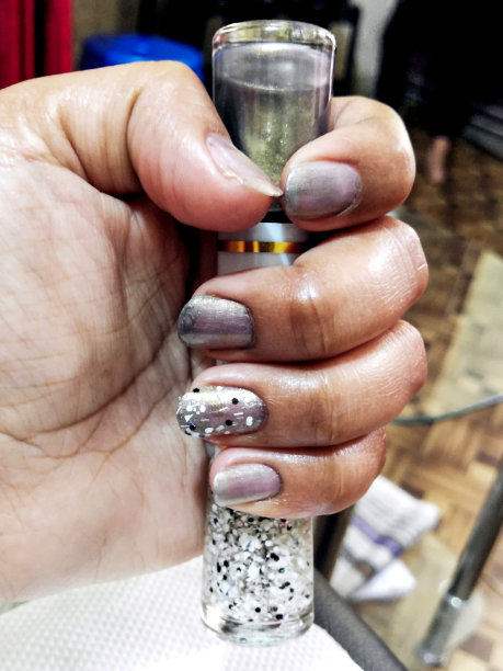 女士的手与时尚的美甲在美容院图片下载