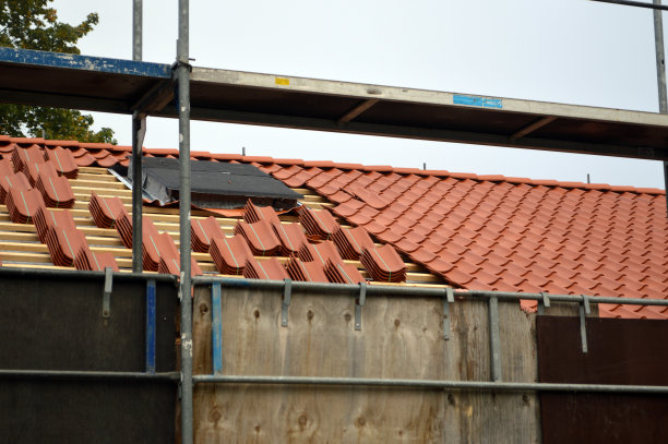 房子上的脚手架。半屋顶的旧建筑图片下载