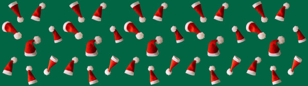 红色圣诞帽上的绿色背景，圣诞节的创意与自由空间的文字，宽横幅图片下载