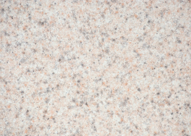 白色花岗岩与少量黑色和橙色夹杂物散落在抛光的天然石材表面。图片下载