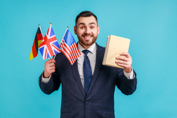 穿着正装，手持德国、英国和美国国旗，面带微笑看着镜头的满意商人或教师图片下载