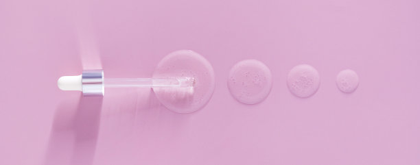 用条幅吸管滴出粉红色背景上的血清图片下载