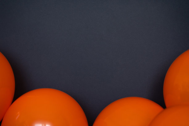 简单的橙色气球在黑色背景图片下载