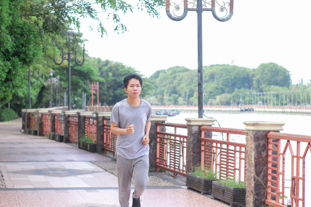 在阳光明媚的日子里，年轻人在公园里锻炼身体图片下载