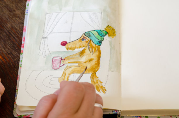 手用毛笔和未完成的水彩画狗。上的图片下载