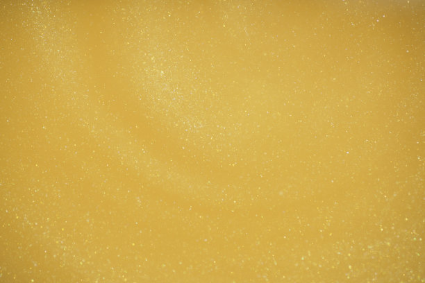 金色闪光抽象背景。迷人的金光闪闪的神奇明亮的节日背景的新年派对装饰图片下载