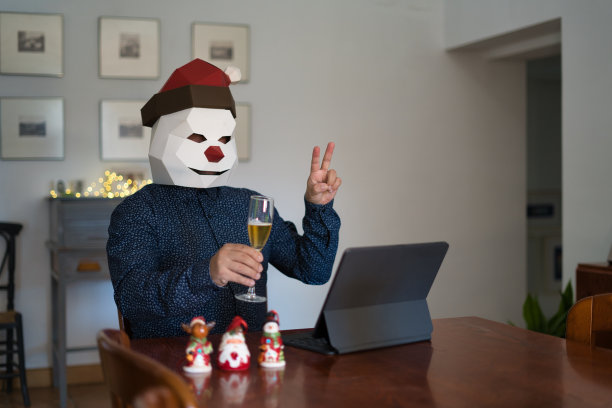 一名戴着圣诞老人面具的男子在视频通话中做出胜利的手势图片下载