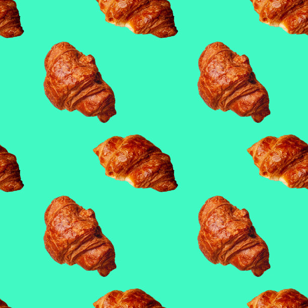 绿色背景上的无缝图案羊角面包图片下载