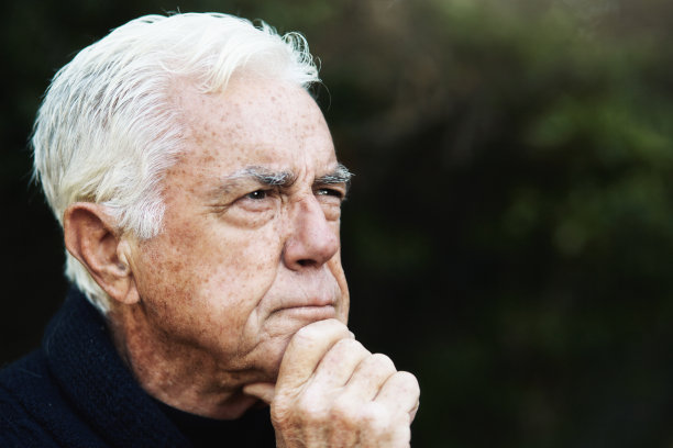 白发苍苍的老人陷入了沉思，手托着下巴，也许在计划着什么图片下载
