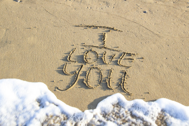 歌词我爱你写在沙滩上的背景。写在沙滩上的情书，有海的泡沫。图片下载