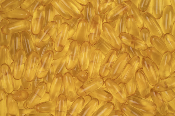 保健品鱼油凝胶胶囊背景。明亮的金色背景与油欧米茄图片下载