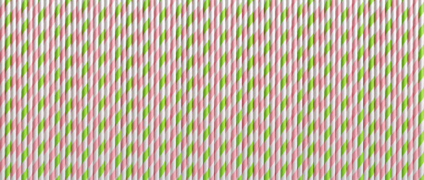 垂直一次性粉红色绿色饮用吸管宏观作为纹理。宽横幅背景的条纹鸡尾酒纸管。环保多彩吸管派对，零浪费理念。图片下载