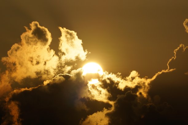 雄伟的太阳从云层中升起，将天空染成金黄色图片下载