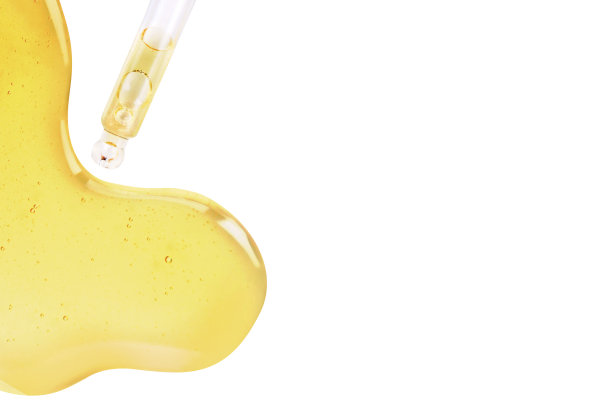 白色背景上一滴乳清或橄榄油的黄色质地。图片下载