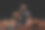 篮球。一个皮肤黝黑、穿着蓝色运动衫的少年自信地坐在地上，旁边是一个篮球。黑色背景。体育游戏概念图片下载