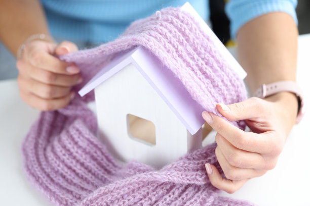 女人的手盖着白色的房子与粉红色的围巾特写图片下载