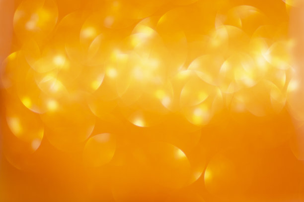 抽象，散焦的金色闪闪发光的圣诞背景与复制空间图片下载