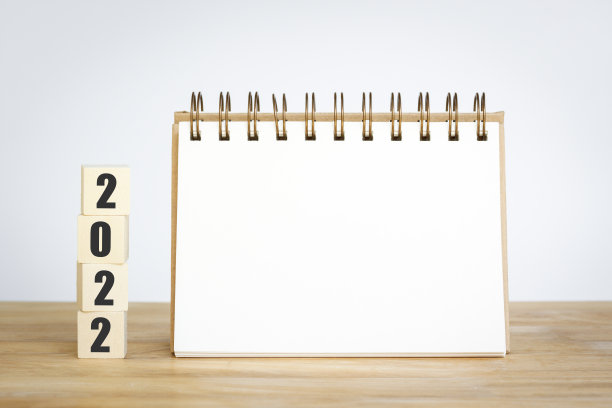 新的2022年新的开始，桌面背景上的立方体木制，记事本上的文本空间模型日历和开始的概念。图片下载