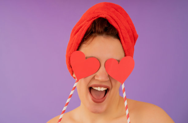 年轻女子头戴毛巾面带微笑。图片下载