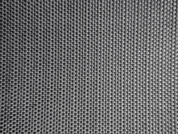 特写黑色塑料垫。背景纹理与交织的带子。图片下载
