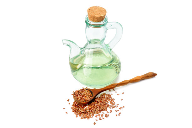 在白色背景上分离的亚麻种子和油。概念-健康的有机食品。图片下载