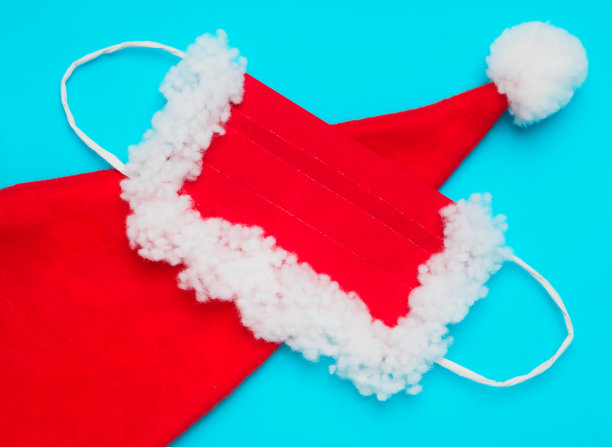 蓝色背景上有圣诞老人的帽子和保护面具图片下载