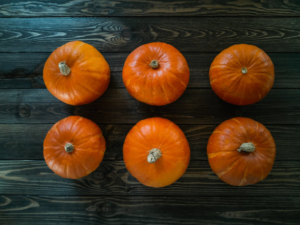 秋天里五颜六色的鲜南瓜，摆在一张旧木桌上图片下载