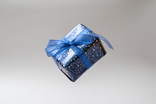 蓝色礼盒和蓝色蝴蝶结。圣诞节礼品盒单一孤立。图片下载