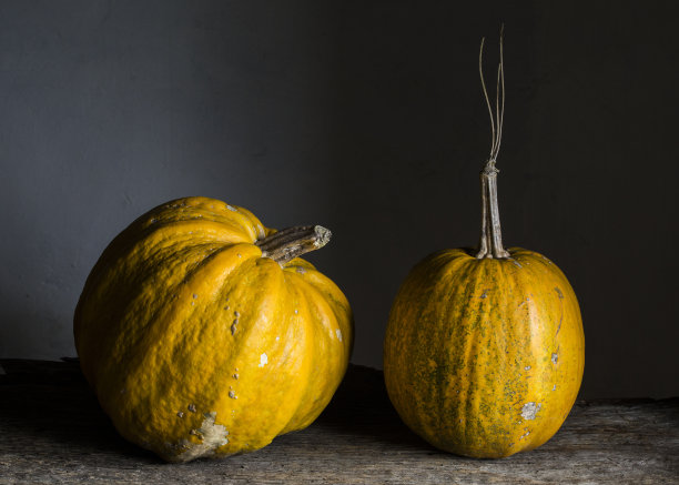 木制底座上的两个南瓜，照片。水平的。副本的空间。黑色食品。图片下载