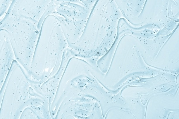 化妆啫喱或美容啫喱质地背景。透明胶原蛋白护肤产品背景。抗菌消毒剂或液体水湿润爽肤水污迹近距离涂抹照片图片下载